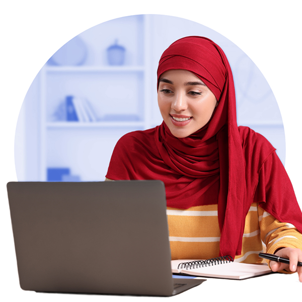 Smiling young woman in hijab working at laptop